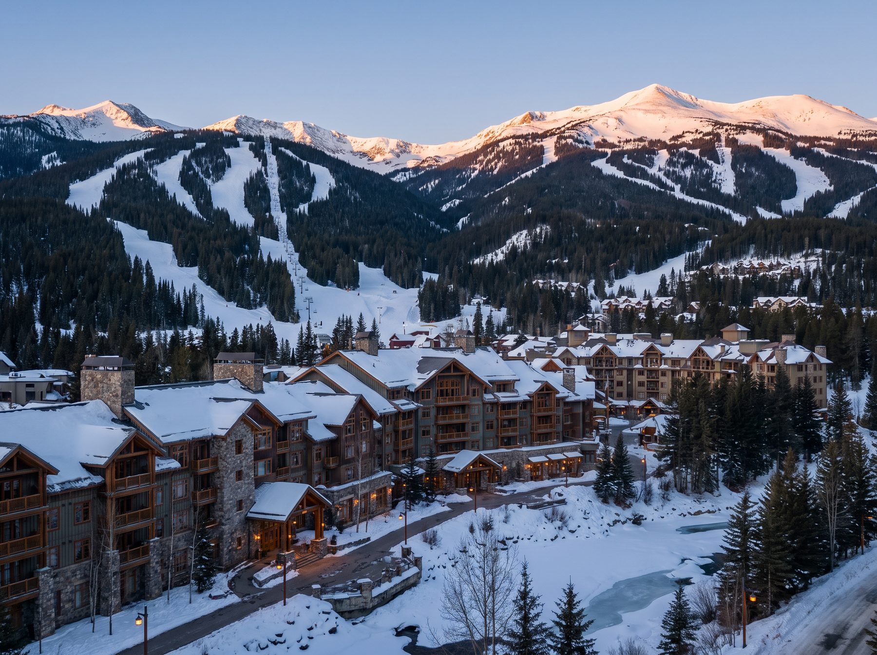 Rocky Mountain resort valley with ski runs and a timber and stone village