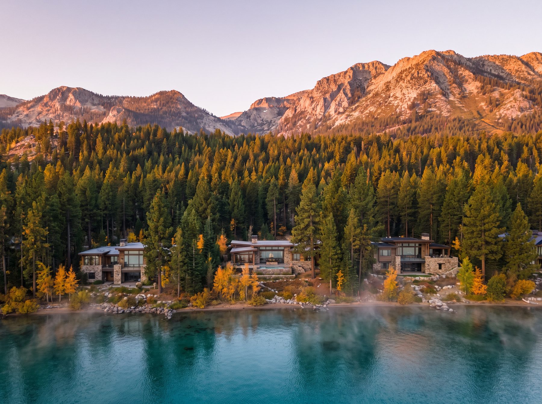 Lake Tahoe basin with modern lakefront homes among pine forest and granite peaks